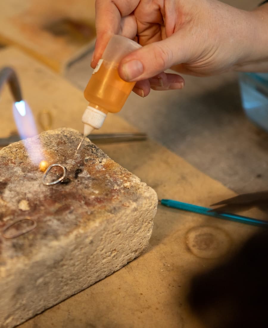 Soldering a silver ring at a jeweller’s bench